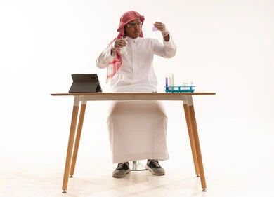 Saudi Scientist Laboratory Experiment with Glassware