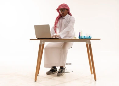 Saudi Scientist Using Laptop in Laboratory