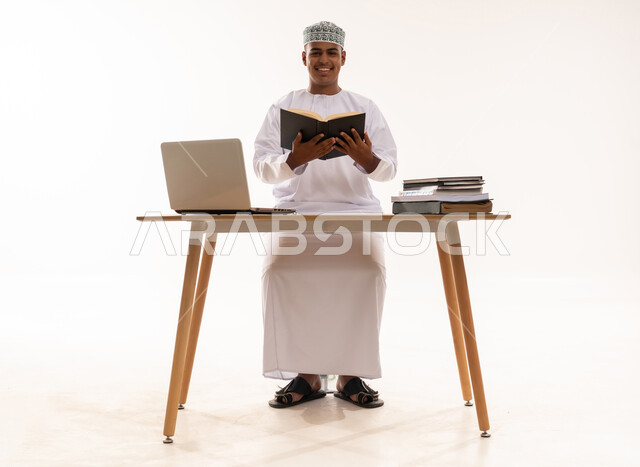Omani Student with Laptop and Books on White Background