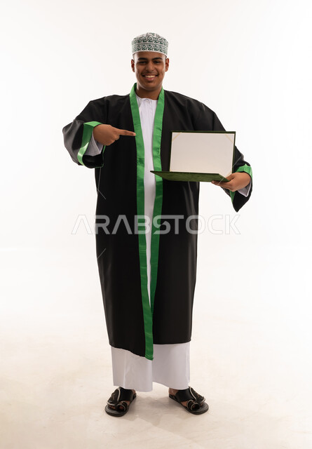 Omani Male Graduate Holding Blank Certificate in Studio