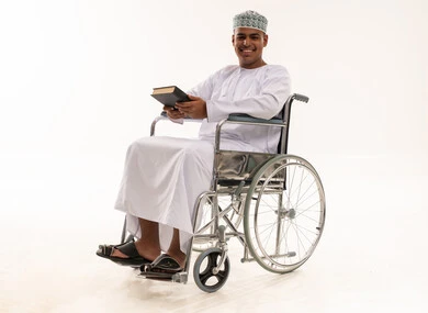 Omani Man in Wheelchair Holding Book Studio Portrait