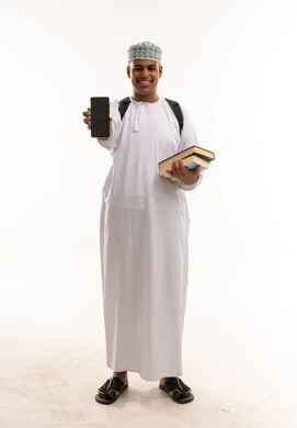 Omani Male Student Holding Smartphone and Books Omani Male Student Holding Smartphone and Books