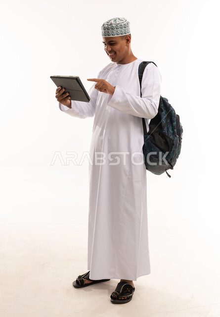 Omani Man with Tablet and Backpack Studio Shot