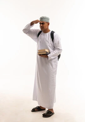 Omani Student in Traditional Dress Holding Books