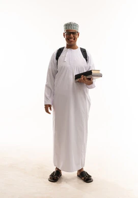 Omani Student in Traditional Dress Holding Books