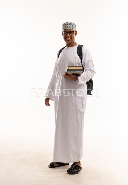 Omani Student in Traditional Dress with Books and Backpack
