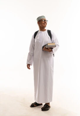 Omani Male Student in Traditional Dress with Books Omani Male Student in Traditional Dress with Books
