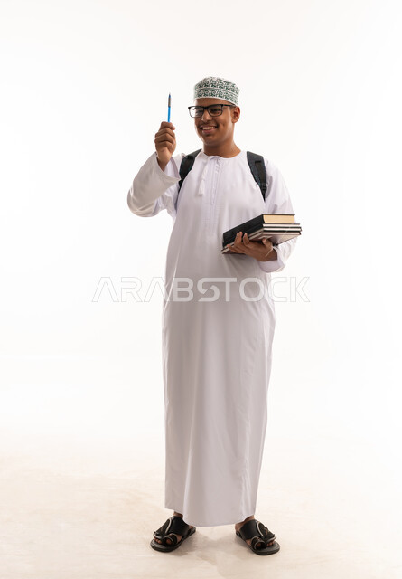 Omani Student in Traditional Dress Holding Books