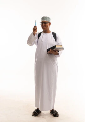 Omani Student in Traditional Dress Holding Books Omani Student in Traditional Dress Holding Books