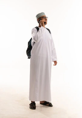 Omani Student in Traditional Dress with Backpack on Phone
