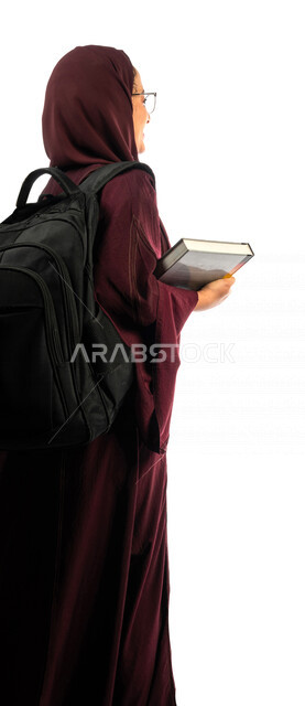 Portrait of a Saudi Arabian Gulf university student carrying university books, preparing for the new academic year, a diligent student eager to go to university, schools and universities, education in the Kingdom of Saudi Arabia, white background.