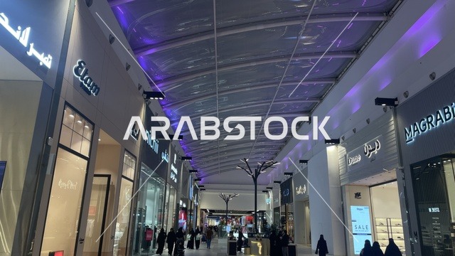 ممشى بسقف مقوس وشفاف يسمح بمرور الضوء، مركز تسوق في حي الأصالة شمال مدينة جدة في المملكة العربية السعودية سبتمبر 2025 ، تجربة تسوق ووجهة ترفيهية متكاملة للعائلة، تصميم عصري وماركات عالمية ومحلية