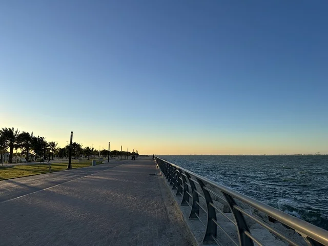 An area with trees and green plants, the waterfront in the city of Dammam at sunset, a vibrant area and a main outlet for the residents and visitors of the Eastern Province, a corniche overlooking the Arabian Gulf in the Kingdom of Saudi Arabia.