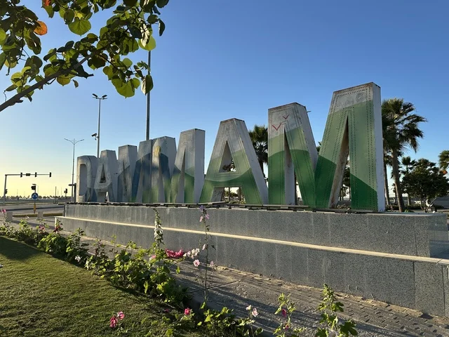 The sculpture of the word "Dammam" in English, the waterfront in the city of Dammam during the day, a vibrant area and a main outlet for the residents and visitors of the Eastern Province, a corniche overlooking the Arabian Gulf in the Kingdom of Saudi Arabia.