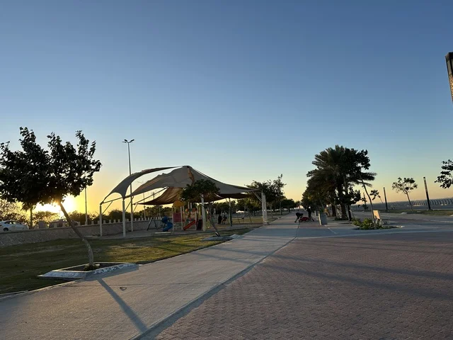 A corniche overlooking the Arabian Gulf in the Kingdom of Saudi Arabia, green trees along the waterfront promenade in the city of Dammam, a vibrant area and a main outlet for residents and visitors of the Eastern Province.