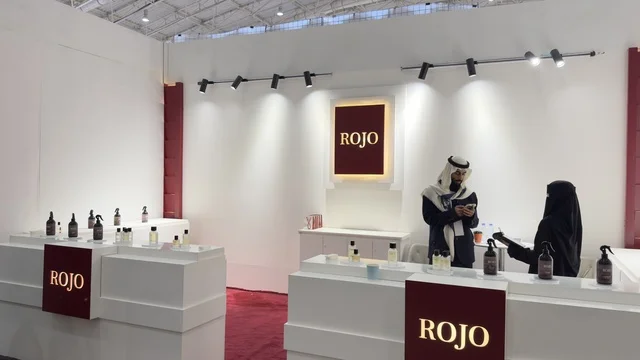 A booth or pavilion bearing a sign with the name "Rogo" for the Blue Oud and International Perfumes Exhibition in Riyadh, held from December 2025 to January 2026 in the Kingdom of Saudi Arabia, featuring major annual events that offer a sensory experience including shopping, learning about the perfume industry, and workshops.