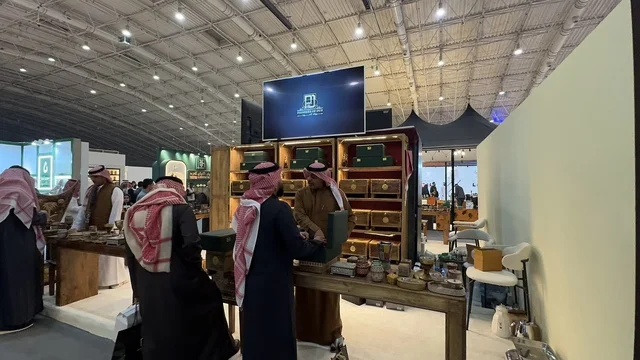 The displayed products are perfume bottles or beauty products. The Blue Oud and International Perfume Exhibition in Riyadh was held from December 2025 to January 2026 in the Kingdom of Saudi Arabia. It is a major annual event that offers a sensory experience including shopping and learning about the perfume industry and workshops.
