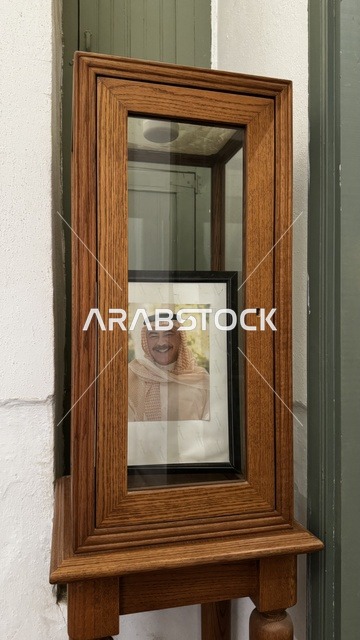 An old wooden box containing an old picture, information in an educational or research framework, personal and official documents, historical and archival documents displayed in a museum in historic Jeddah, Saudi Arabia, memorabilia and items of cultural value.