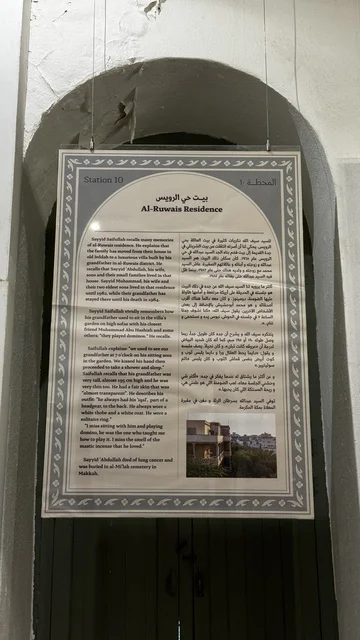 لوحة معلومات عن بيت حي الرويس، معلومات في إطار تعليمي أو بحثي، المستندات الشخصية والرسمية، وثائق تاريخية وأرشيفية معروضة في متحف في جدة التاريخية في المملكة العربية السعودية، مقتنيات تذكارية وعناصر ذات قيمة ثقافية.