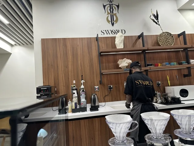 A café in the House of Culture in Dammam, Eastern Province, Saudi Arabia, the Dammam Public Library, educational and interactive activities for all groups, a cultural and knowledge landmark that enhances creativity and the arts, diverse cultural and community events, an inspiring environment that brings together cultures, knowledge, and art, spaces for exhibitions and workshops.