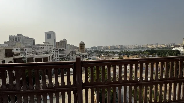 A balcony with a wooden railing, the historic city of Jeddah with ancient Arab and Islamic architectural design, historical tourist sites in the Kingdom of Saudi Arabia, historical landmarks in Jeddah Al-Balad, the historic city of Jeddah, the archaeological buildings in the historic district of Jeddah.