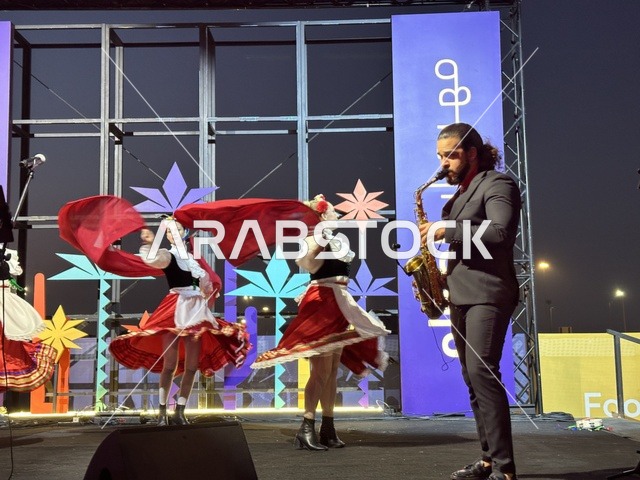 A guitar performance and a Mexican folkloric dance at a food festival in the Ithra outdoor gardens in Dhahran, Eastern Province, Saudi Arabia, on December 28, 2025. A global tasting experience, family-friendly and entertaining atmosphere, enjoyable outdoor seating, international and local restaurants.
