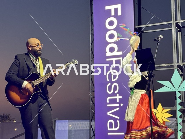 عزف على الجيتار ورقصة فلكلورية مكسيكية فى  مهرجان للطعام فى حدائق إثراء الخارجية بالظهران، الشرقية ، المملكة العربية السعودية، يوم 28 من ديسمبر 2025 ،  تجربة تذوق عالمية ، أجواء عائلية وترفيهية، جلسات خارجية ممتعه، مطاعم دولية ومحلية