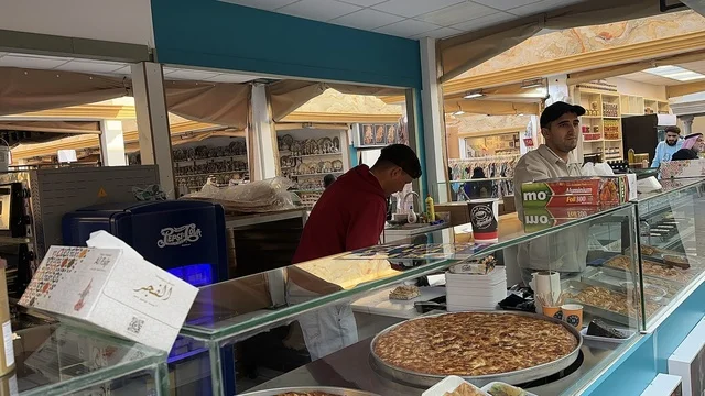 A kiosk for selling sweets and traditional baked goods, activating tourism and economic movement, a tourist and entertainment attraction, the global city January 2026 on the shores of the Arabian Gulf and Lake Sehat in the Eastern Province of Dammam, experience the different cultures of the country, a place to spend enjoyable time with family.