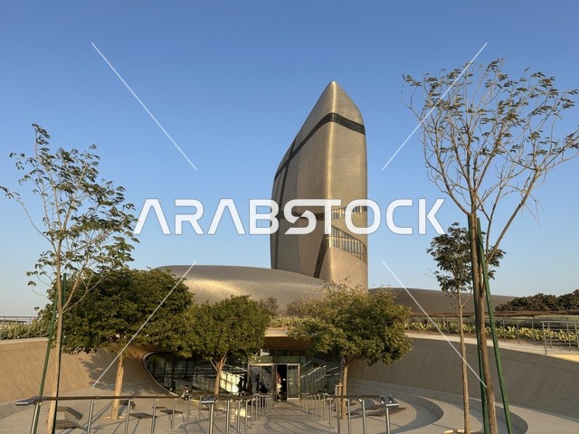 مبنى مركز الملك عبد العزيز الثقافي العالمي (إثراء) بتصميم معماري معاصر، واجهة معدنية حديثة ومساحات خارجية مفتوحة، نموذج للتطور الثقافي والعمراني، معلم حضري في الظهران بالمنطقة الشرقية
