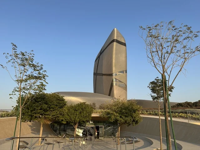 The King Abdulaziz Center for World Culture (Ithra) building features contemporary architectural design, a modern metal facade, and open outdoor spaces, serving as a model for cultural and urban development, and is an urban landmark in Dhahran in the Eastern Province.