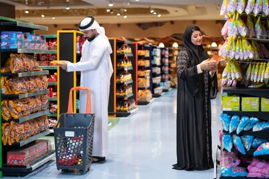 Emirati Couple Shopping for Groceries in Supermarket