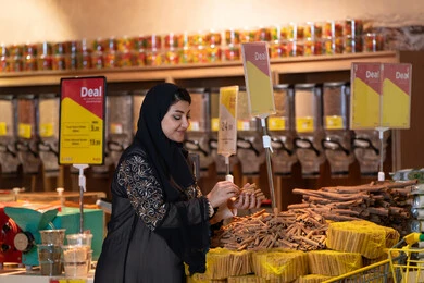 Saudi Woman Shopping for Spices in Supermarket