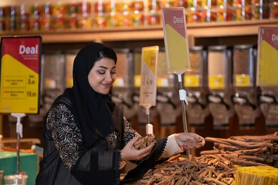 Saudi Woman Shopping for Spices in Supermarket