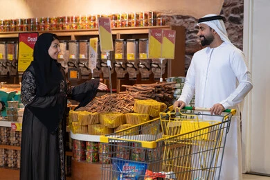 Emirati Couple Shopping with Cart in Supermarket