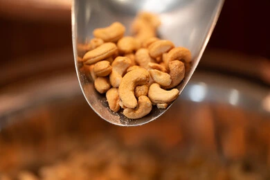 Roasted Cashew Nuts in Metal Scoop Close-up Roasted Cashew Nuts in Metal Scoop Close-up