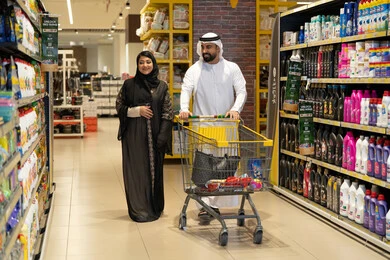 Emirati Couple Shopping in Supermarket Aisle