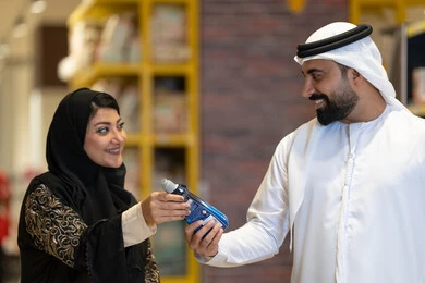 زوجان إماراتيان يتسوقان المنتجات في السوبر ماركت