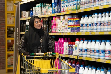 Arab Woman with Shopping Cart in Supermarket Aisle