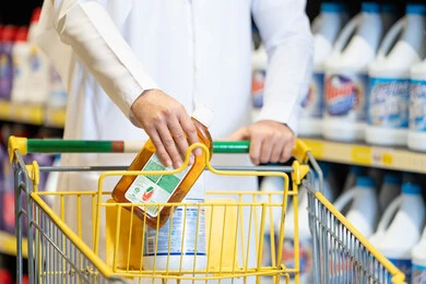 Arab Man Shopping for Cleaning Supplies in Supermarket