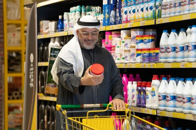 Arab Man Shopping for Cleaning Supplies in Supermarket