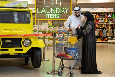 Emirati Couple Shopping in Supermarket Laundry Section