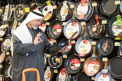Arab Man Shopping for Frying Pan in Kitchenware Store