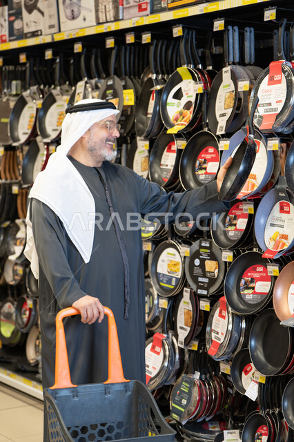 Arab Man Shopping for Kitchenware in Supermarket