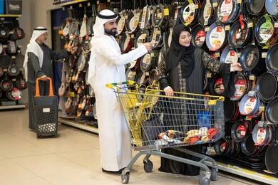 زوجان إماراتيان يتسوقان أدوات المطبخ في السوبر ماركت