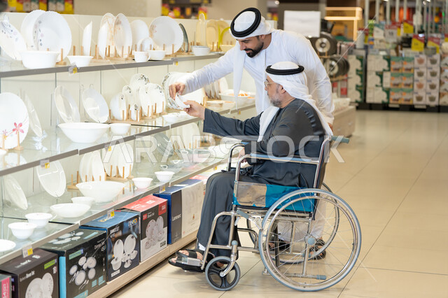 رجل إماراتي على كرسي متحرك يتسوق أدوات منزلية
