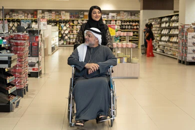 Emirati Man in Wheelchair Shopping at Supermarket