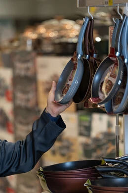 Person Shopping for Non-Stick Frying Pans in Store