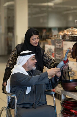 Emirati Man in Wheelchair Shopping for Kitchenware