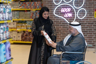 Arab Man in Wheelchair Shopping in Supermarket Aisle