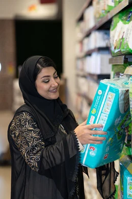 امرأة سعودية تتسوق حفاضات أطفال في السوبر ماركت